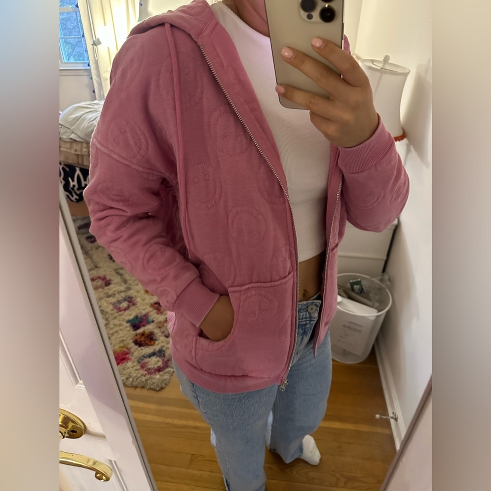 Pink smiley face sweatshirt.
